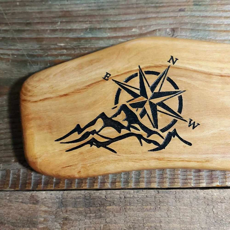 Deska do podawania przekąsek z drewna oliwnego po lewej stronie deski jest wypalony wzór, góry i róża wiatrów, wymiary deski 11,5x41cm