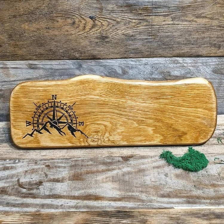 Drewniana deska do krojenia i podawania przekąsek. Deska posiada wypalony ozdobny wzór, góry kompas.  Wymiary deski - 15x43 cm